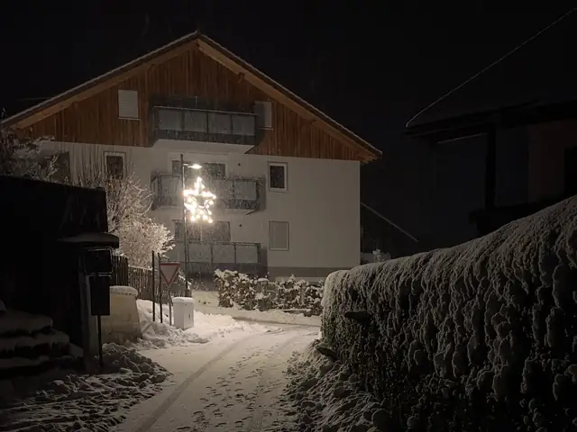 Detroit house at night in winter with snow on the ground